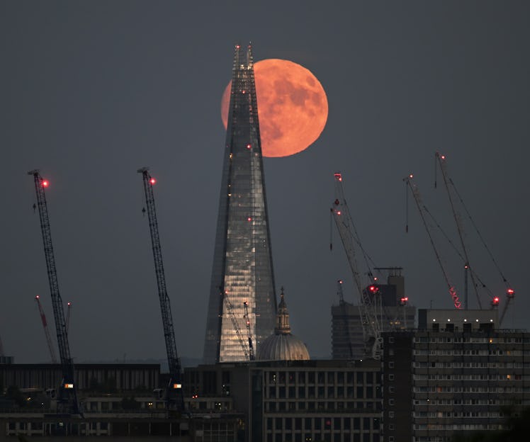 complete "Strawberry Moon" (in June) rises above important landmarks of the city of London.  Taken from Parliemne...